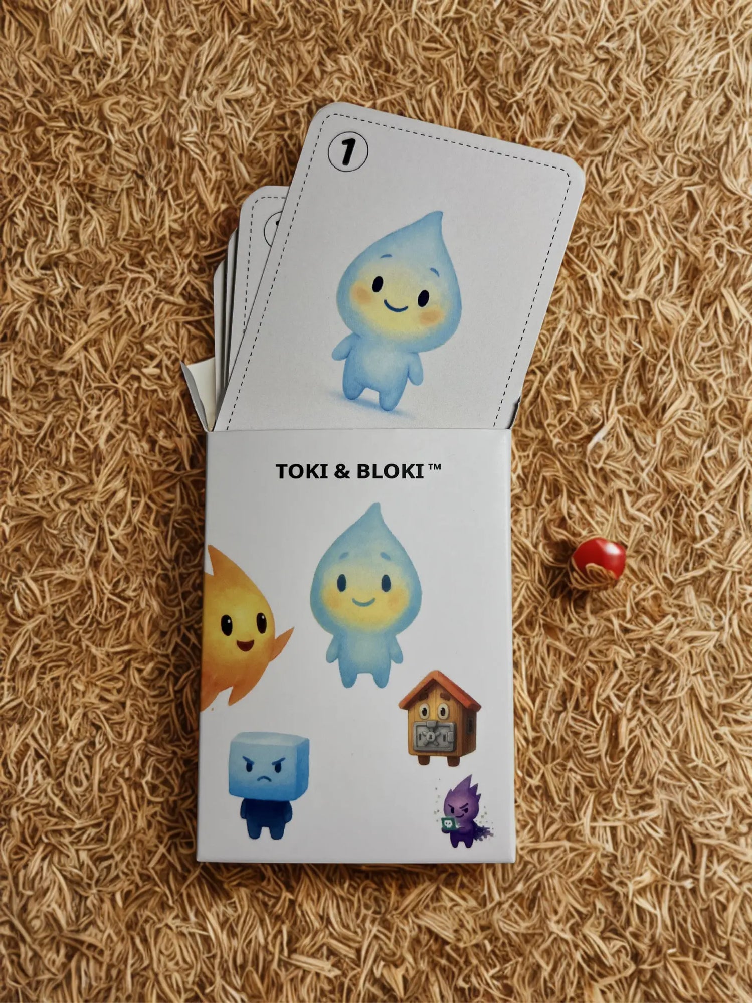 Geöffnete Verpackung des Toki & Bloki™ Kartenspiels mit sichtbaren Spielkarten